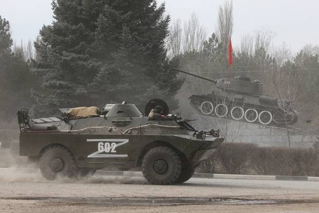 Russian Army military vehicle drives along a street in Armyansk