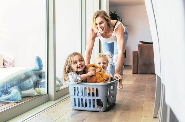 Mother playing with her children at home