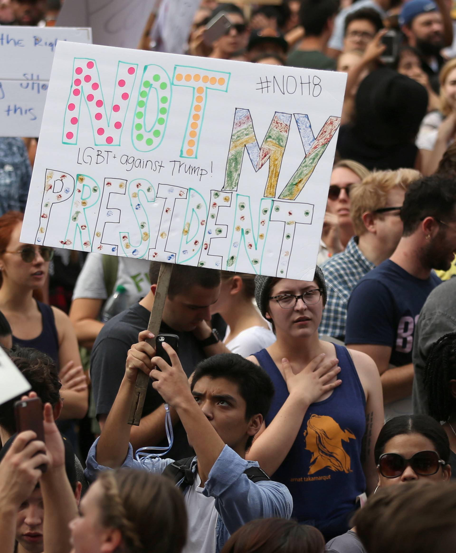 People gather outside a federal building during a march and rally against the election of Republican Donald Trump as President of the United States in Los Angeles