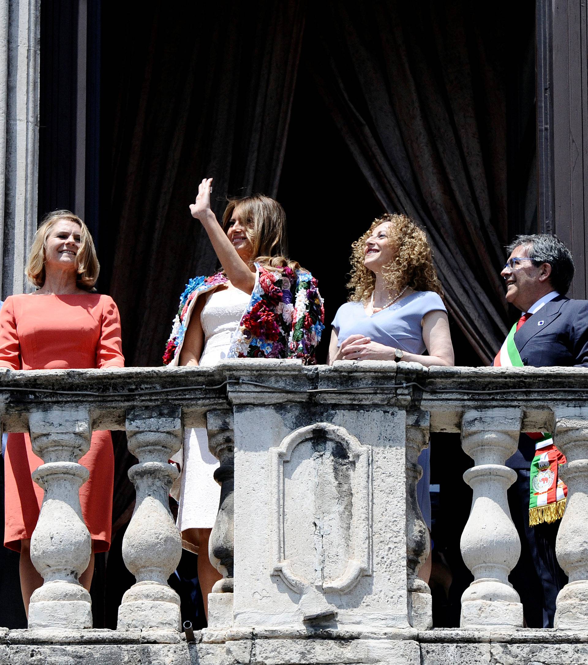 Emanuela Mauro, Joachim Sauer, Malgorzata Tusk, U.S. first lady Melania Trump, Mayor of Catania Enzo Bianco and Akie Matsuzaki, look out from the balcony of the Town Hall in Catania