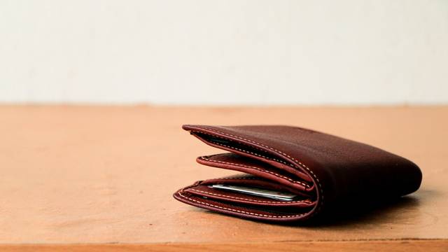 Brown,Leather,Wallet,Put,On,Wooden,Table,Top