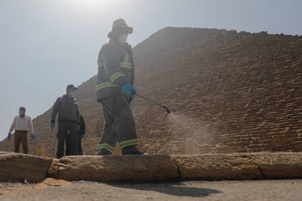 A member of the medical team sprays disinfectant as a precautionary move amid concerns over the coronavirus disease (COVID-19) outbreak at the Great Pyramids, Giza, on the outskirts of Cairo