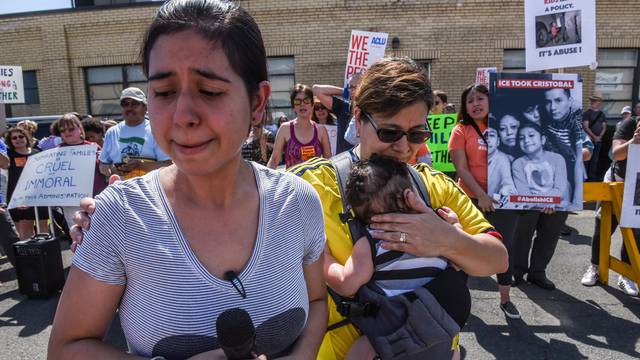 People participate in a protest against recent U.S. immigration policy that separates children from their families when entering the United States as undocumented immigrants in front of a Homeland Security facility in Elizabeth