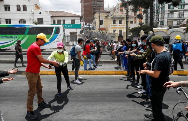 People clean debris from the streets in the aftermath of the last days