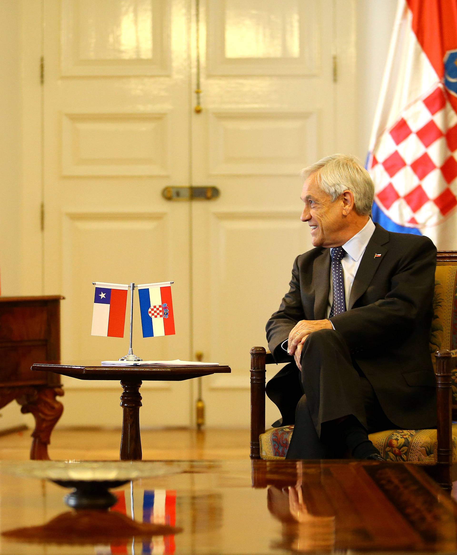 Chile's President Sebastian Pinera talks to Croatia's President Kolinda Grabar-Kitarovic at the government house in Santiago