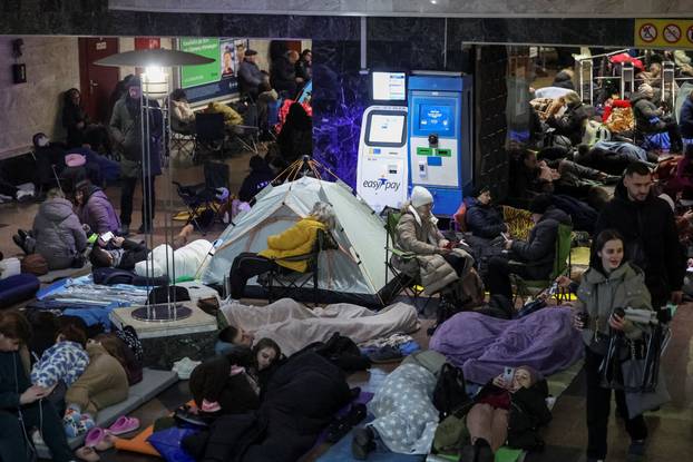 People take shelter inside a metro station during a Russian missile and drone attack in Kyiv