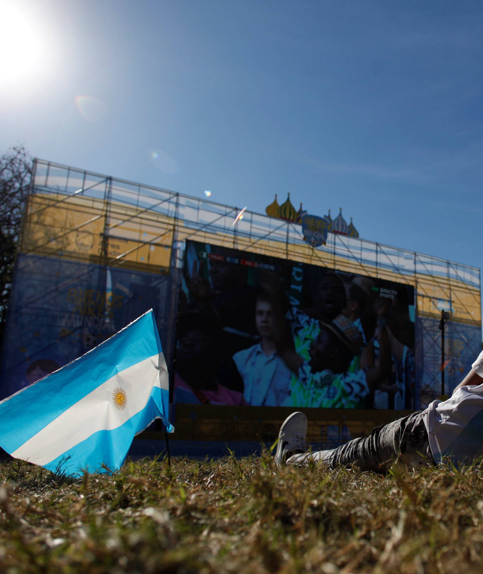 An Argentina fan watches a broadcast of the World Cup Group D Nigeria v Iceland soccer match, at a public viewing area at a square in Buenos Aires