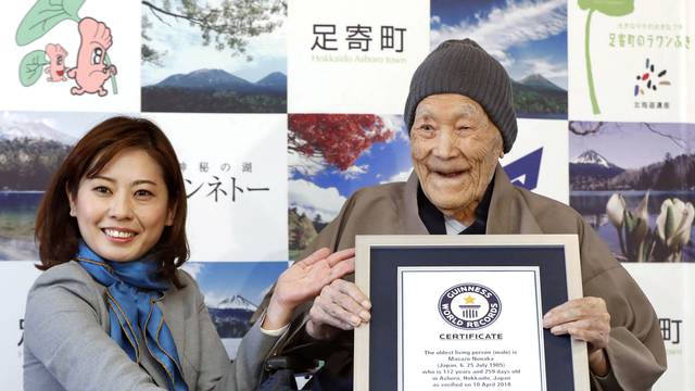 Japanese Masazo Nonaka, who was born 112 years and 259 days ago, receives a Guinness World Records certificate naming him the world's oldest man during a ceremony in Ashoro
