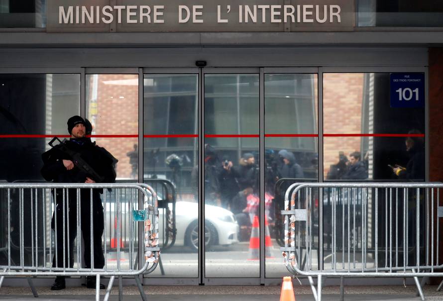 A French policeman stands guard in front of the entrance of the judiciary police offices in Nanterre