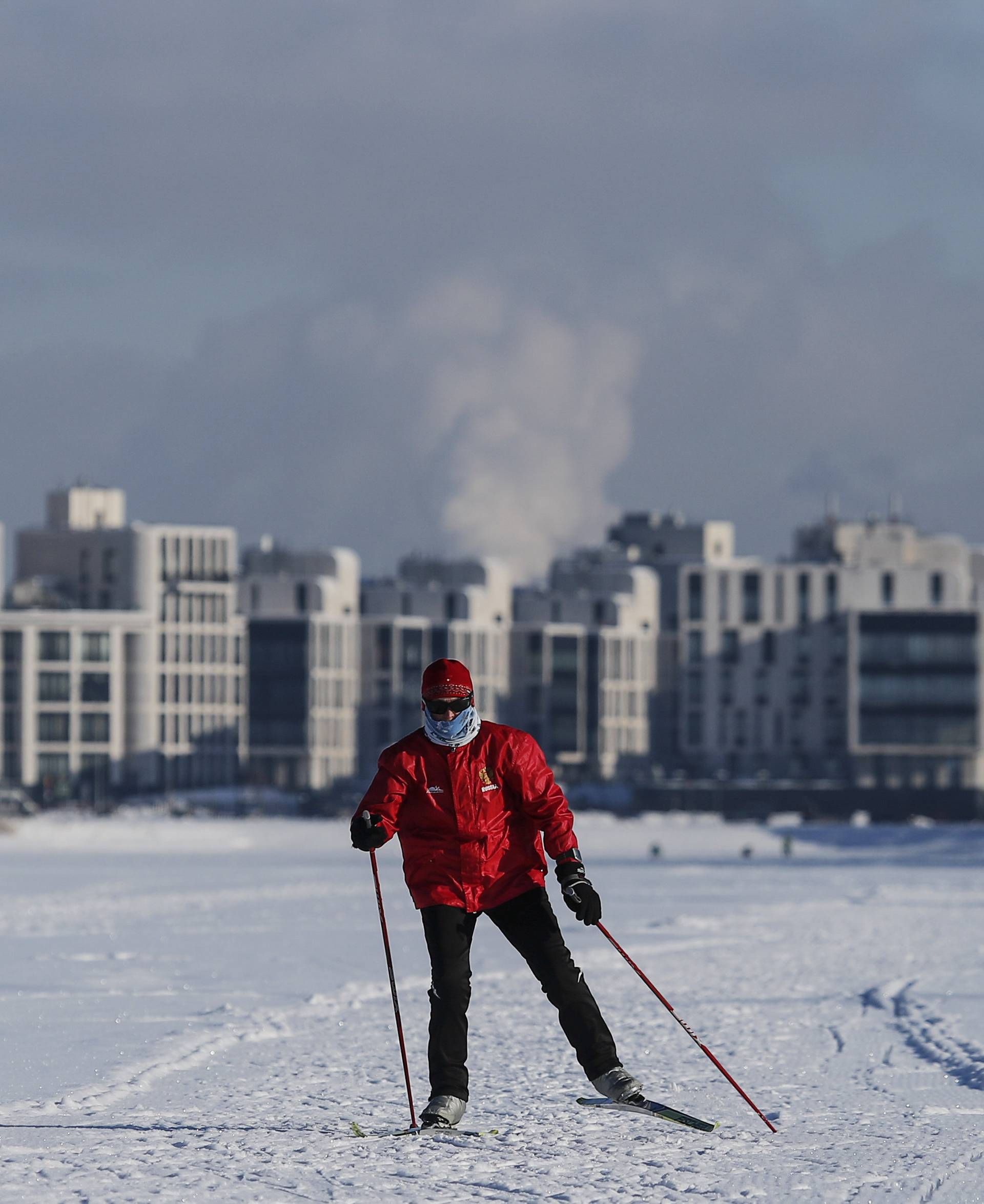 A skier walks on the ice-covered Rowing Channel in St. Petersburg