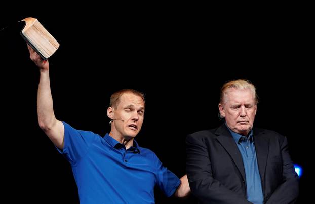 U.S. President Donald Trump stands on stage as Pastor David Platt prays for him at the McLean Bible Church, in Vienna