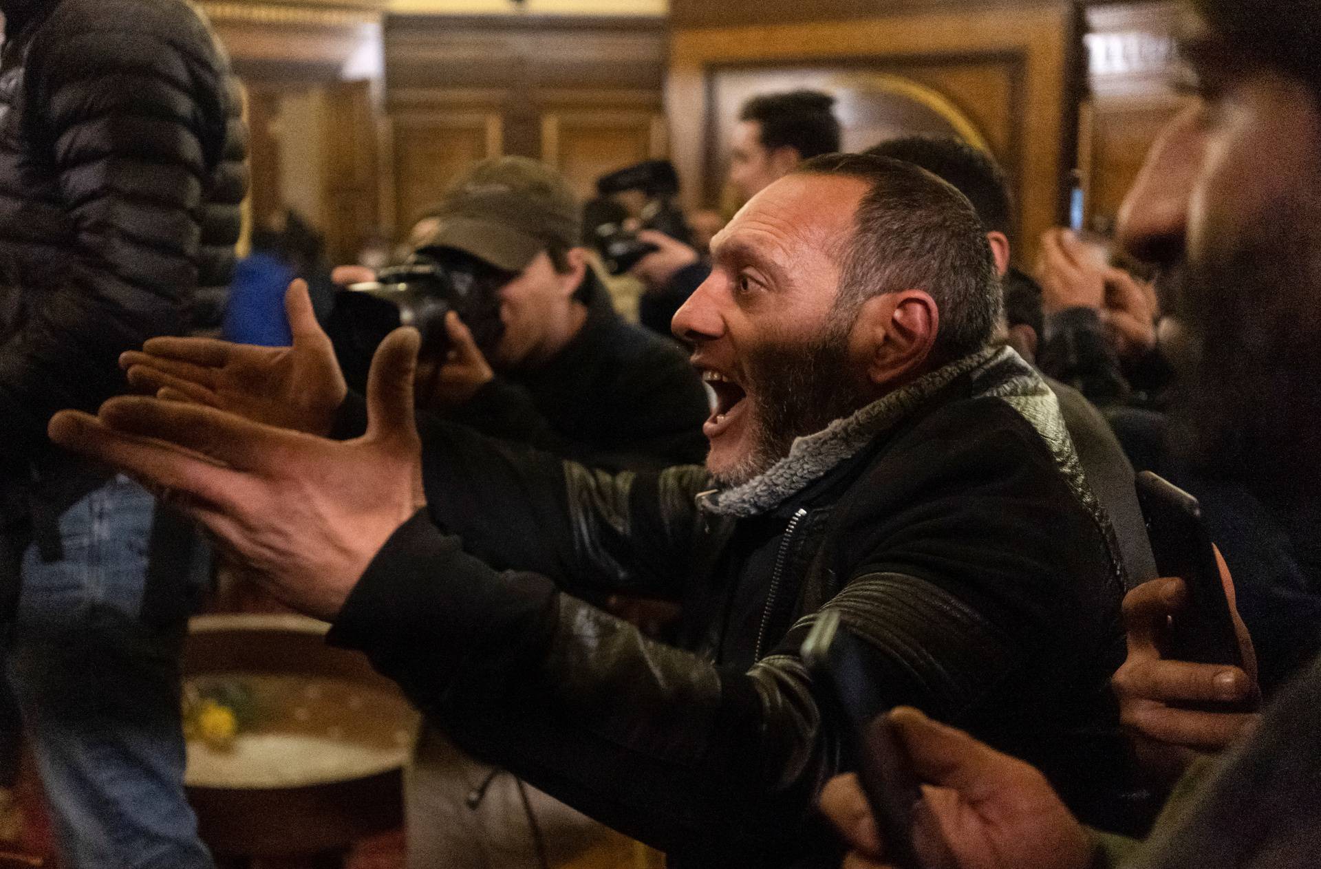 A protester reacts inside the parliament in Yerevan