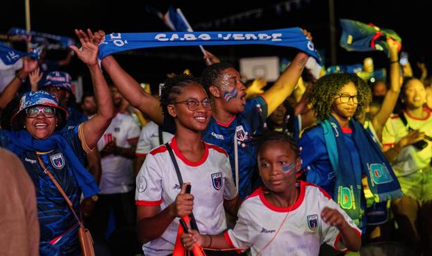 Fans of the Cape Verde national soccer team celebrate as they watch a World Cup group stage match against Uruguay in Praia