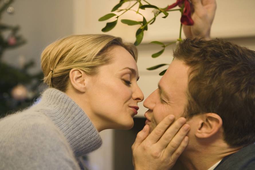 Couple kissing under the mistletoe