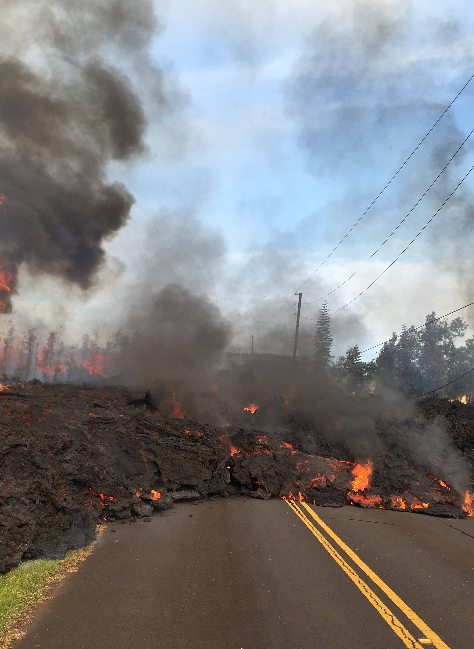 Lava advances along a street near a fissure in Leilani Estates, on Kilauea Volcano's lower East Rift Zone, Hawaii
