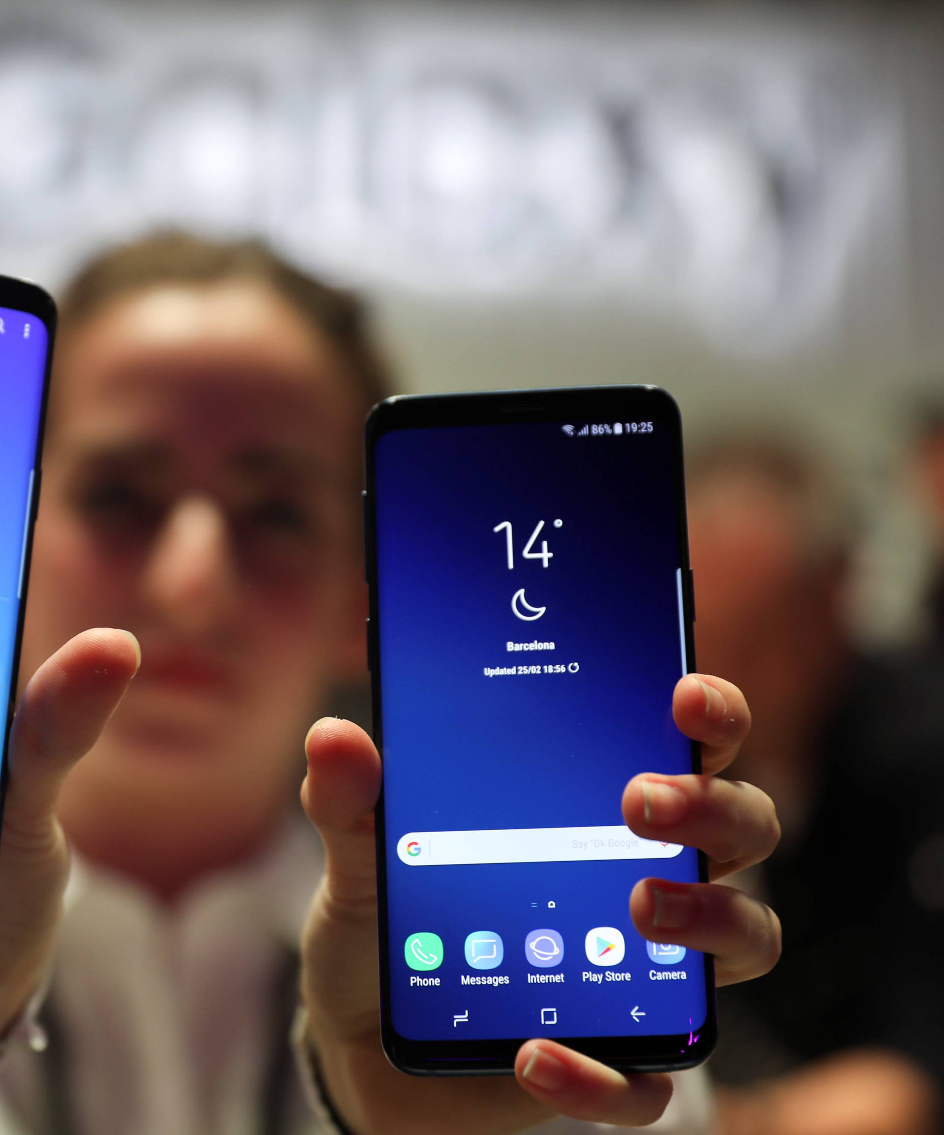 A hostess shows up Samsung's new S9 (R) and S9 Plus devices after a presentation ceremony at the Mobile World Congress in Barcelona