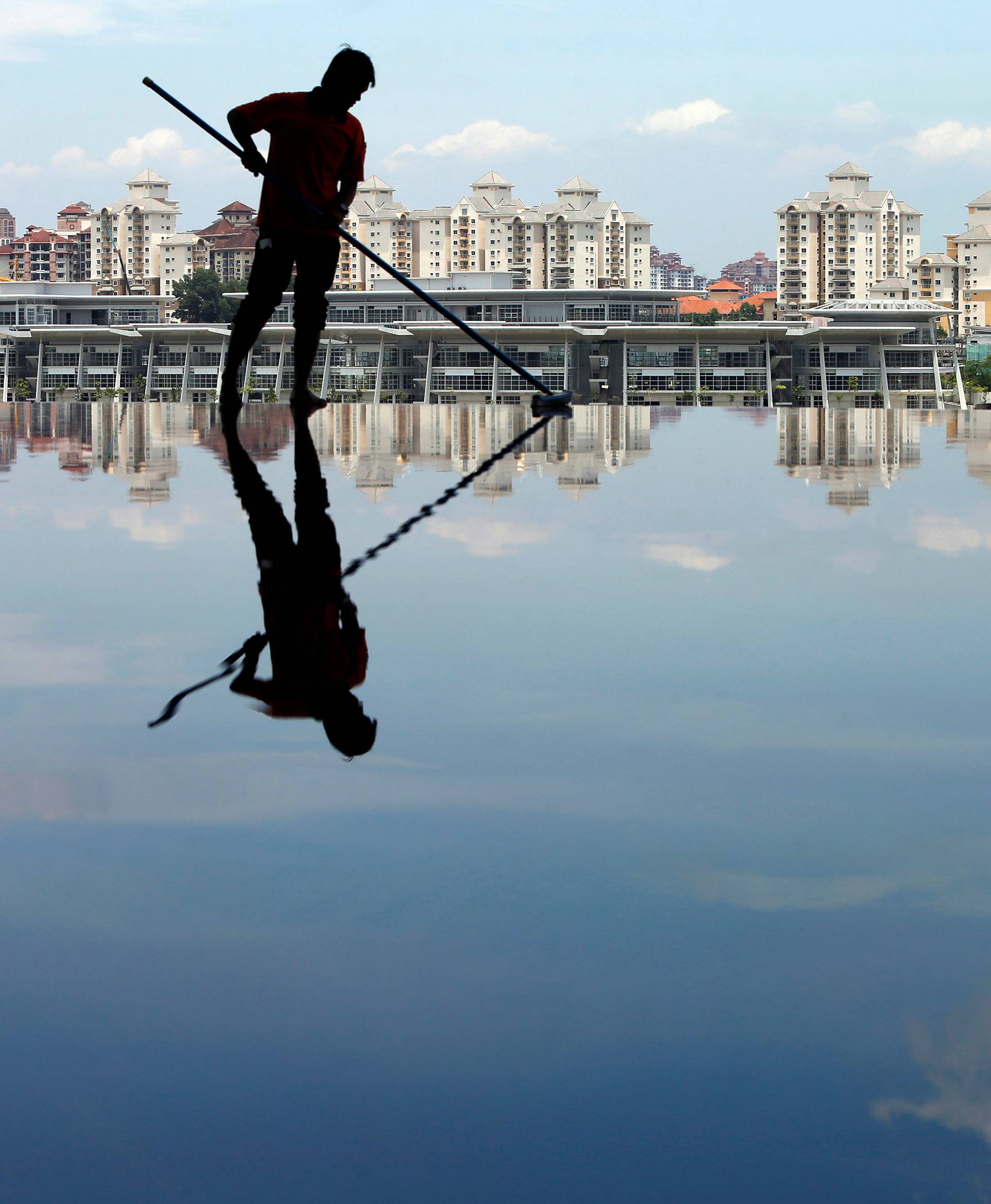 File photo of a worker cleaning up a pool inside the Tuanku Mizan Zainal Abidin mosque in Putrajaya