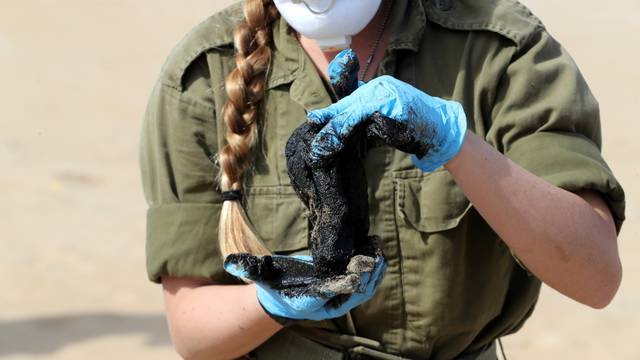 Israel's beaches blackened by tar after offshore oil spill