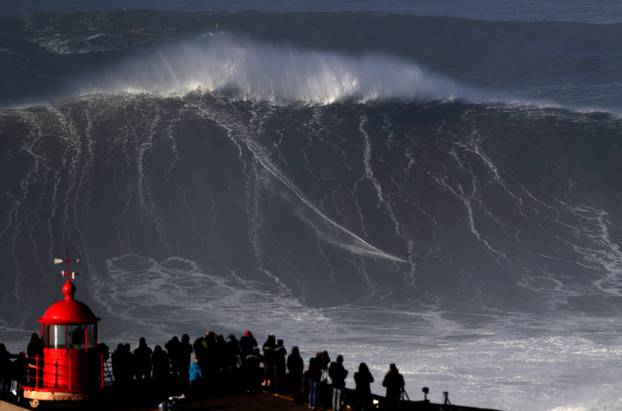 Big wave surfer Sebastian Steudtner of Germany drops in on a large wave at Praia do Norte in Nazare