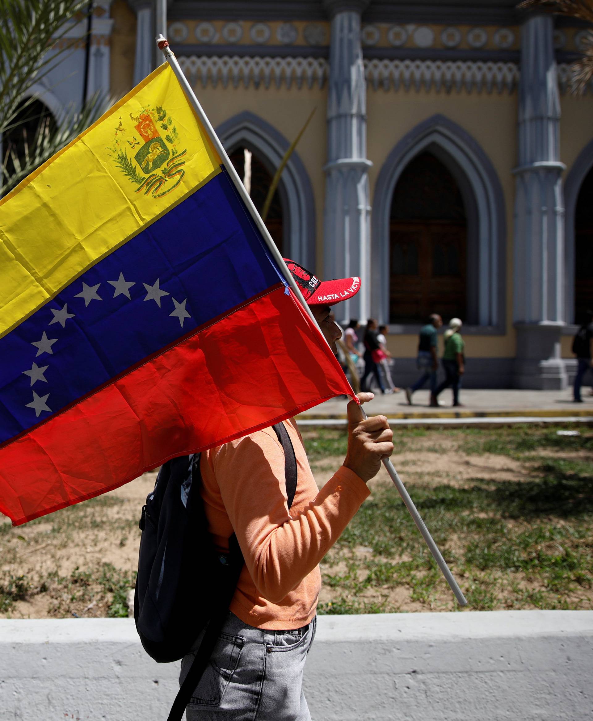 A supporter of Venezuela's President Nicolas Maduro holds a Venezuelan flag during a rally in support of him in Caracas