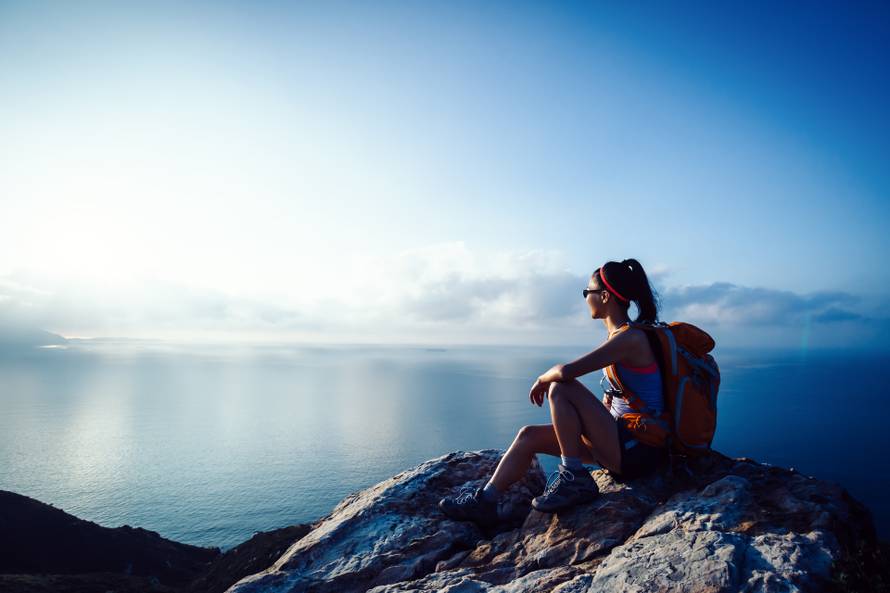 Young,Woman,Hiker,At,Sunrise,Seaside,Mountain,Peak