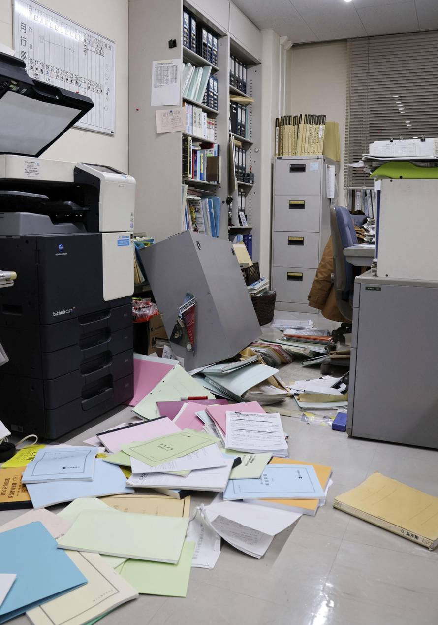 Bookshelves and documents that fell during an earthquake are seen at Kyodo News' Hakodate bureau in Hakodate