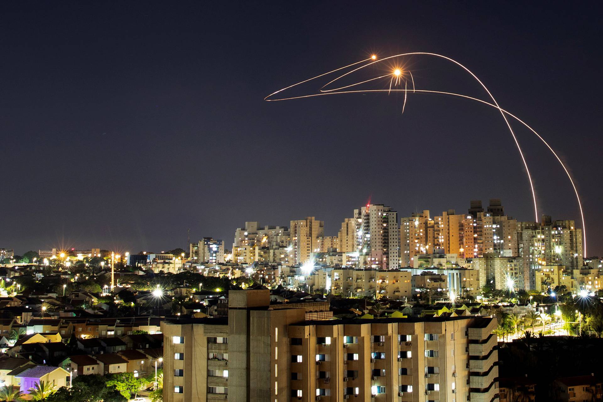 Streaks of light are seen as Israel's Iron Dome anti-missile system intercepts rockets launched from the Gaza Strip towards Israel, as seen from Ashkelon, Israel