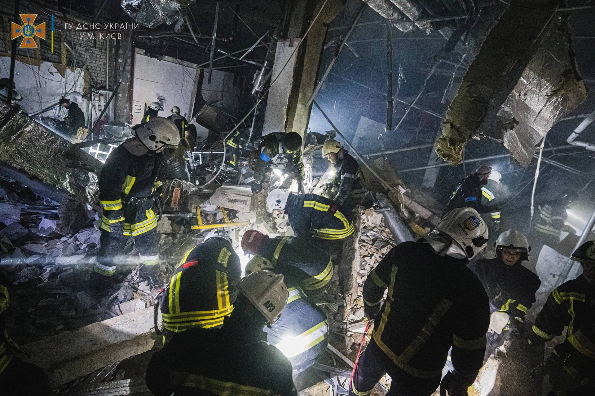 Rescuers work at the site of a shopping mall damaged by an airstrike in Kyiv