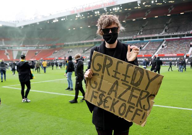 Manchester United fans protest against their owners before the Manchester United v Liverpool Premier League match