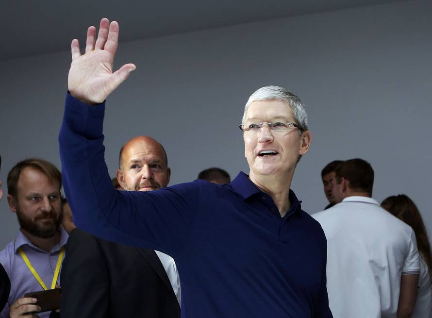 Tim Cook waves during an Apple media event in San Francisco