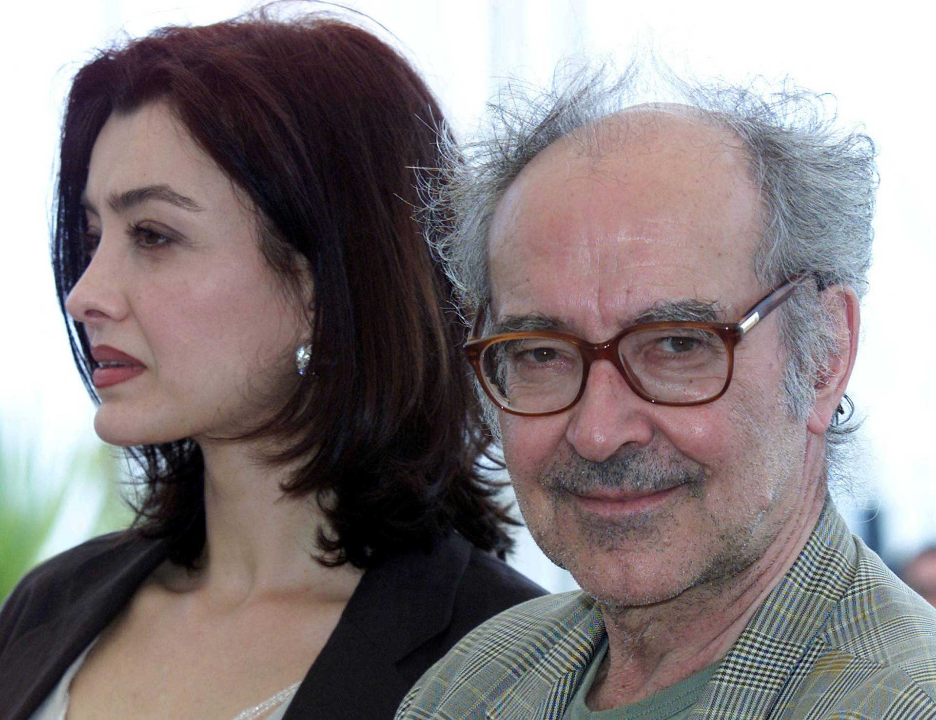 FILE PHOTO: Swiss director Jean Luc Godard (R) smiles as he stands with actress Cecile Camp (L) for their film "..