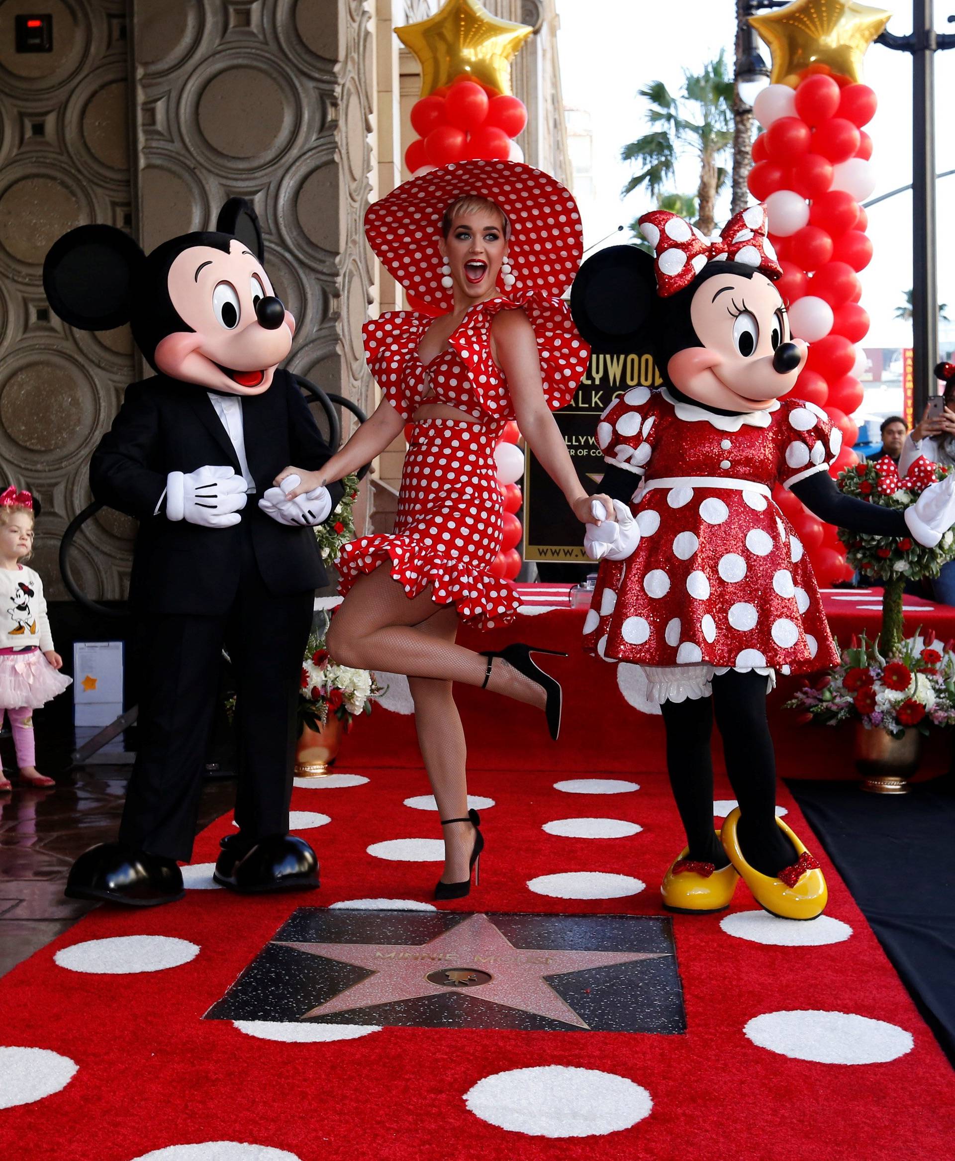 Singer Perry poses with the characters of Mickey Mouse and Minnie Mouse at the unveiling of the star for Minnie Mouse on the Hollywood Walk of Fame in Los Angeles