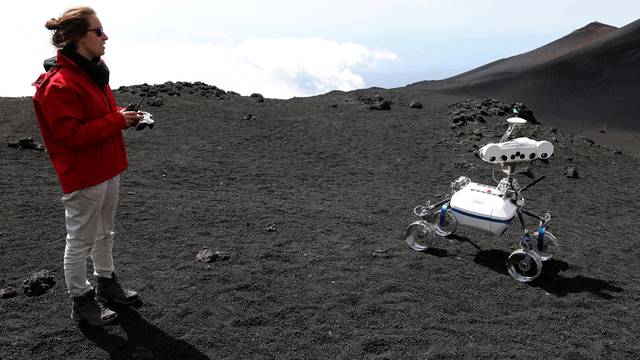 A scientist from German Aerospace Center controls a robot on the Mount Etna