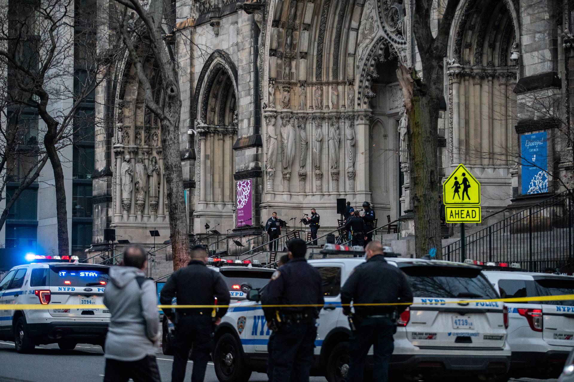 Police officers investigate after a man opened fire outside the Cathedral Church of St. John the Divine in the Manhattan borough of New York City