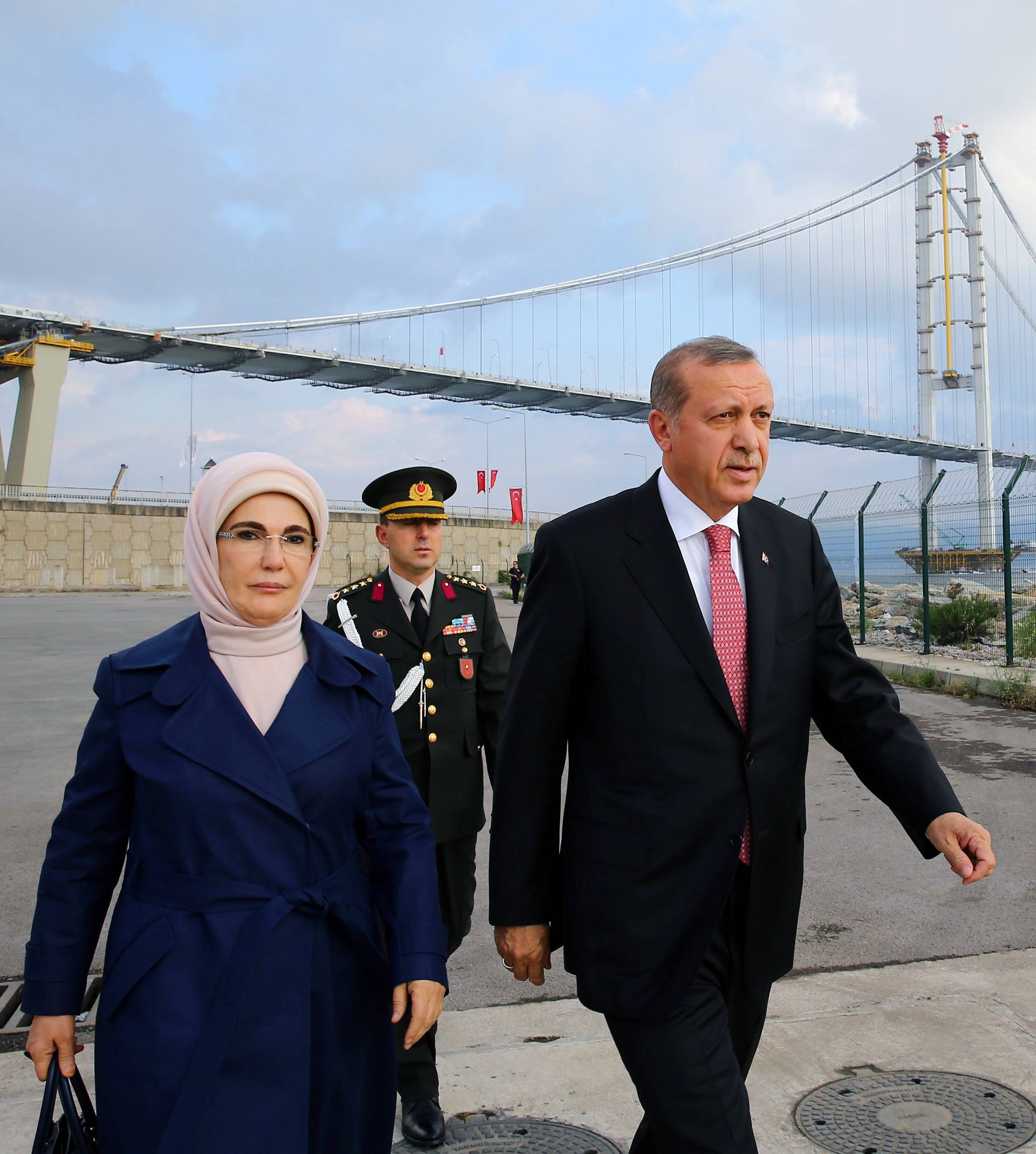 Turkish President Tayyip Erdogan and his wife Emine Erdogan arrive for the opening ceremony of Osman Gazi bridge in Kocaeli