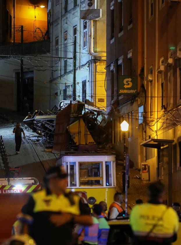 First responders work at the site of a funicular accident in Lisbon