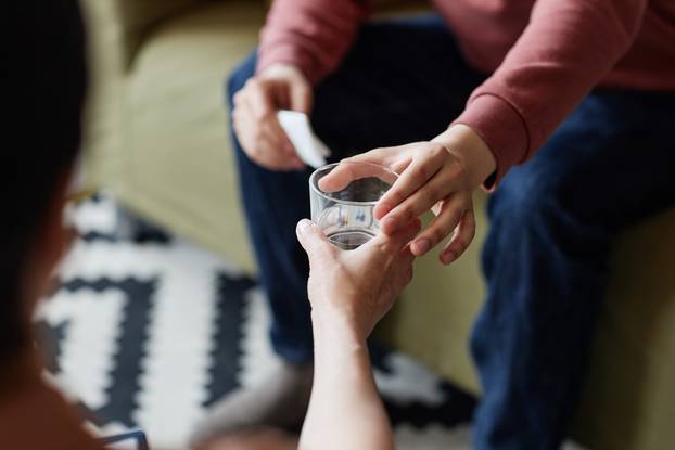 Psychologist giving glass of water to atient