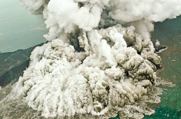 A plume of ash rises as Anak Krakatau erupts in Indonesia