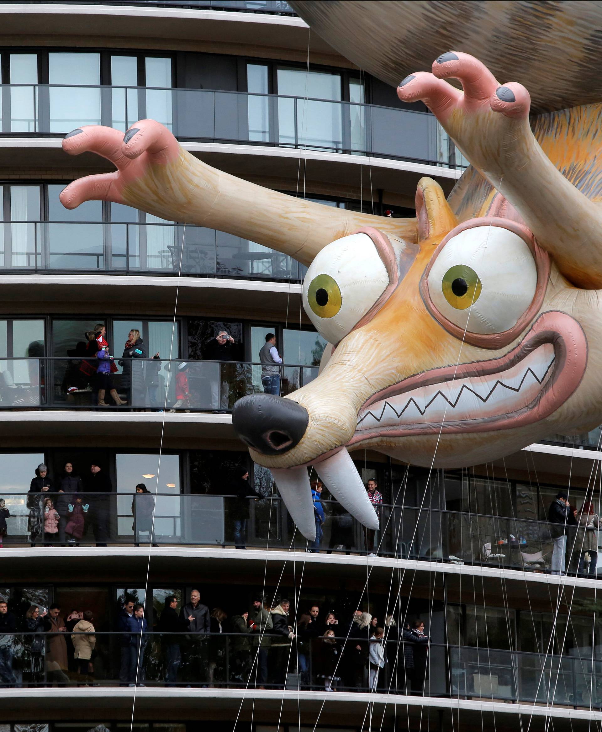 Ice Age's Scrat balloon is carried by crowds gathered on terraces along West 59th Street during the 90th Macy's Thanksgiving Day Parade in Manhattan, New York, U.S.