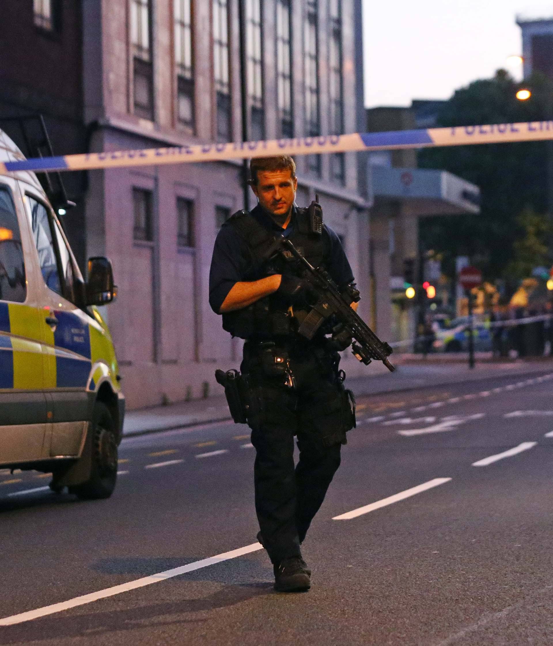 Police officers attend to the scene after a vehicle collided with pedestrians in the Finsbury Park neighborhood of North London