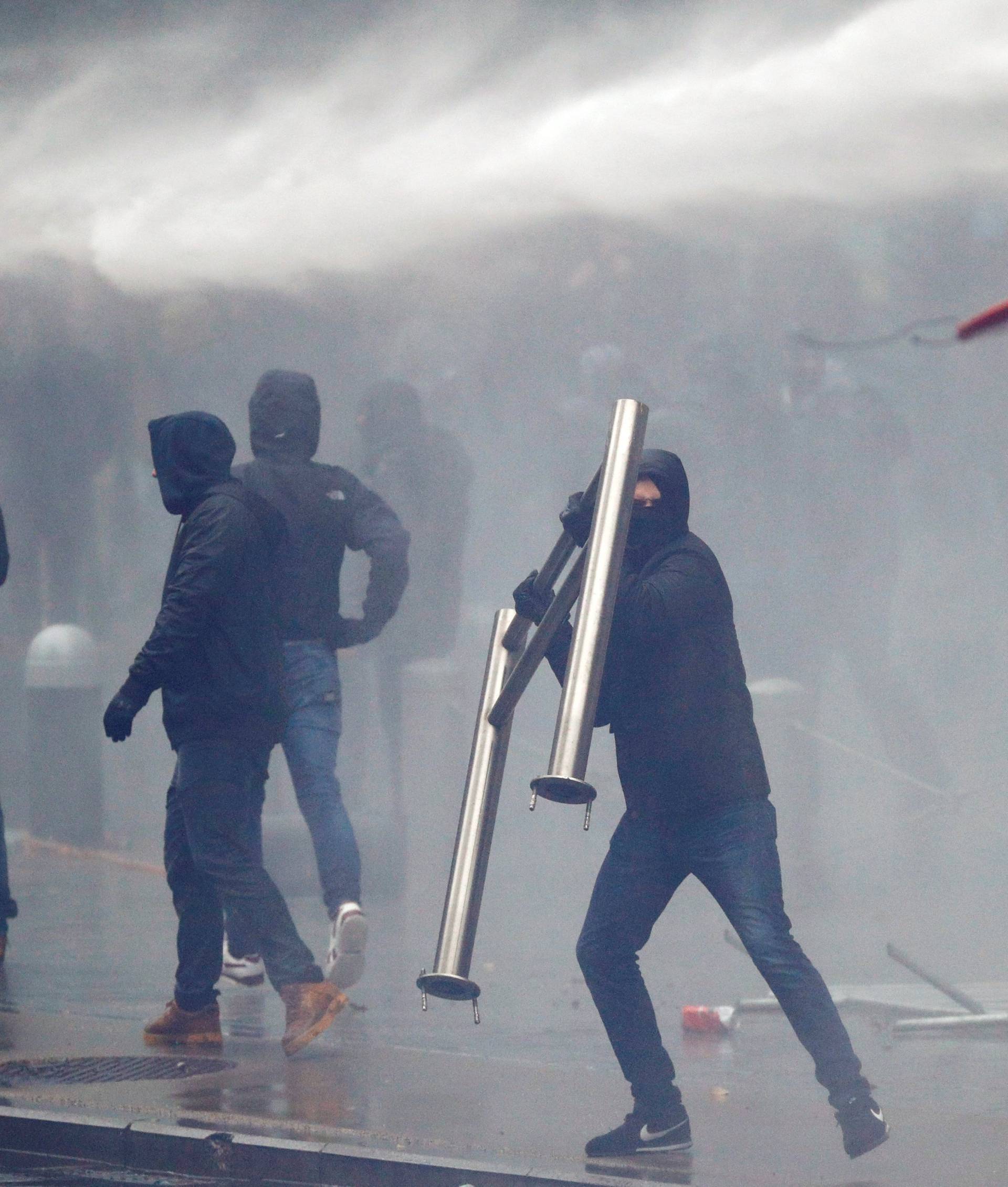 Far-right supporter throws a barricade during a protest against Marrakesh Migration Pact in Brussels