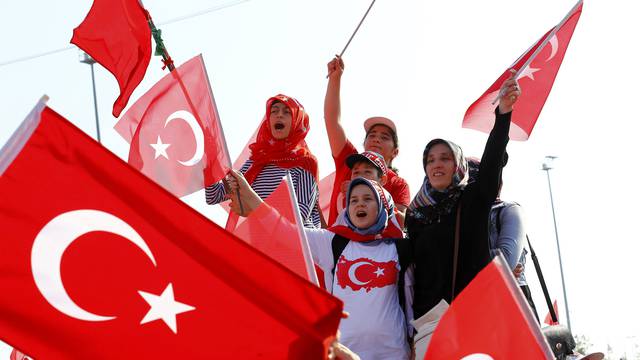 People wave Turkey's national flags during the Democracy and Martyrs Rally in Istanbul