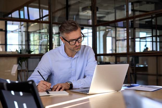 Mature,Business,Man,Executive,Manager,Looking,At,Laptop,Computer,Watching