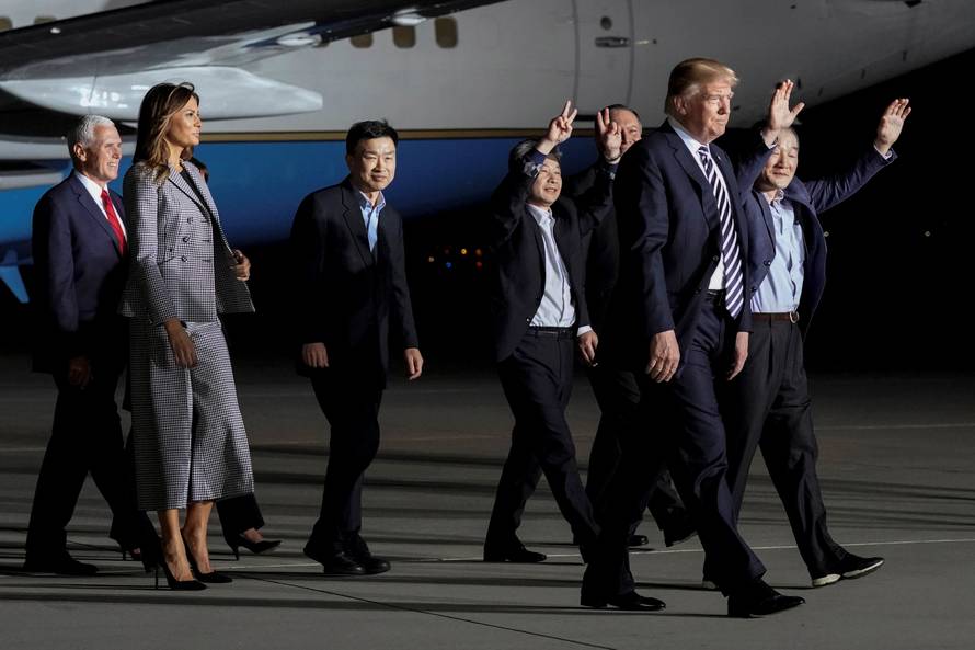 The three Americans released from detention in North Korea, Tony Kim, Kim Hak-song and Kim Dong-chul, walk next to U.S.President Donald Trump as they arrive at Joint Base Andrews