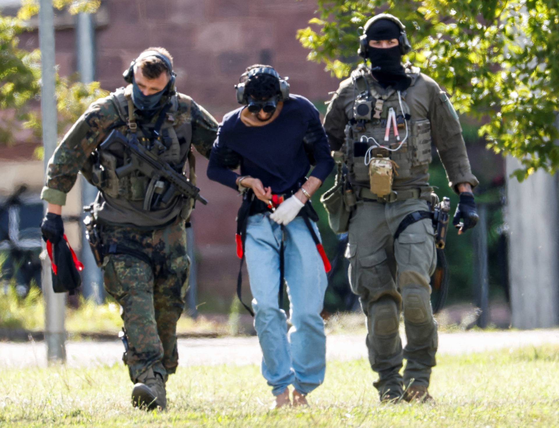 Police escort the suspect for Solingen's stabbing rampage, in Karlsruhe