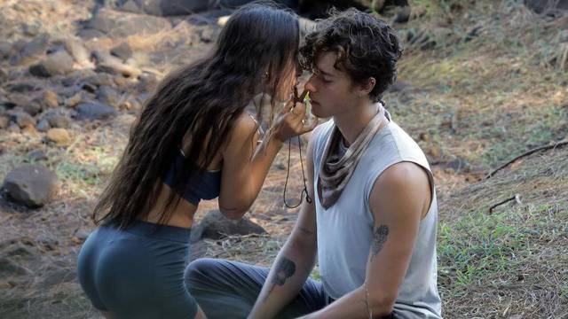 ** PREMIUM EXCLUSIVE ** Shawn Mendes appears to get a bizarre shamanic plant medicine blown up his nose - as the newly single singer gets close to a mystery brunette during a beach meditation session.