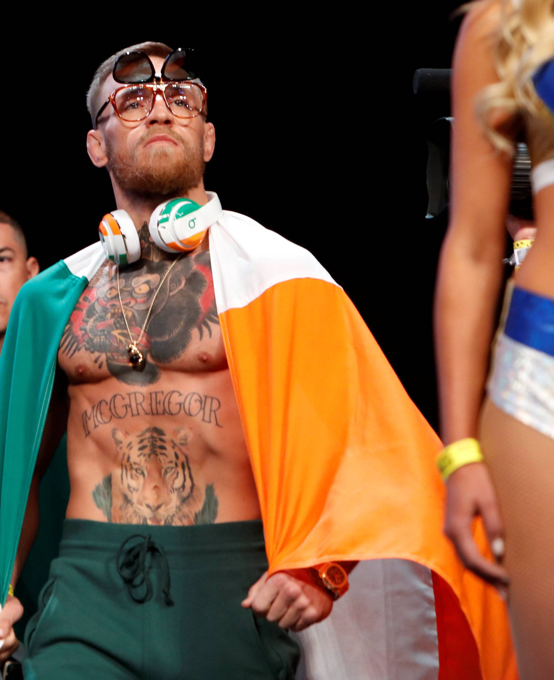 UFC lightweight champion Conor McGregor of Ireland arrives on stage for his official weigh-in at T-Mobile Arena in Las Vegas