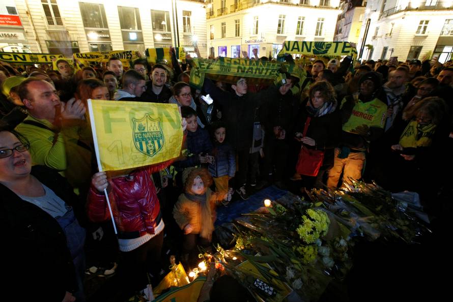Fans gather near a row of yellow tulips in Nantes' city center after news that newly-signed Cardiff City soccer player Emiliano Sala was missing after the light aircraft he was travelling in disappeared between France and England