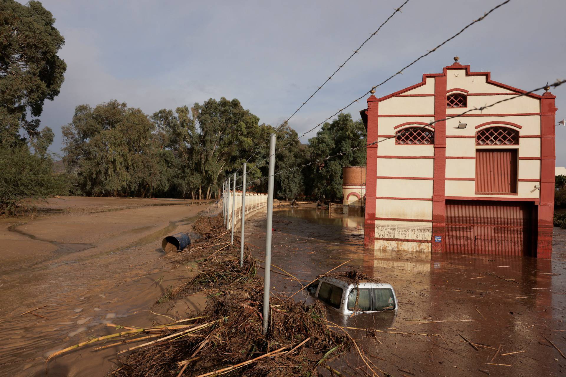 A car sits submerged in a flooded area after heavy rains and floods in Alora