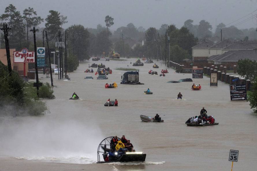 Residents use boats to evacuate flood waters from Tropical Storm Harvey along Tidwell Road east Houston, Texas